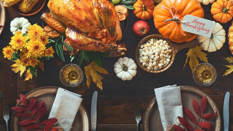 table set for thanksgiving with turkey and pumpkin